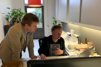 Twee mannen werken samen op kantoor.